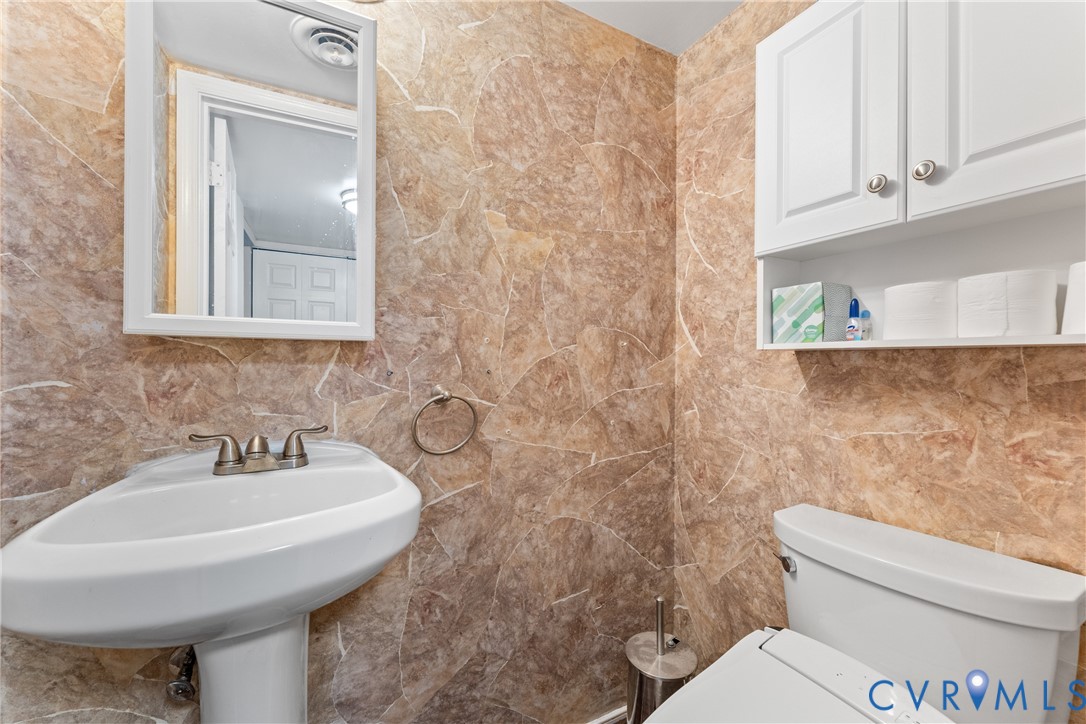 10709 Solaris Court Chesterfield, VA 23832 - Photo 16 of 34 a bathroom with a sink a toilet and mirror