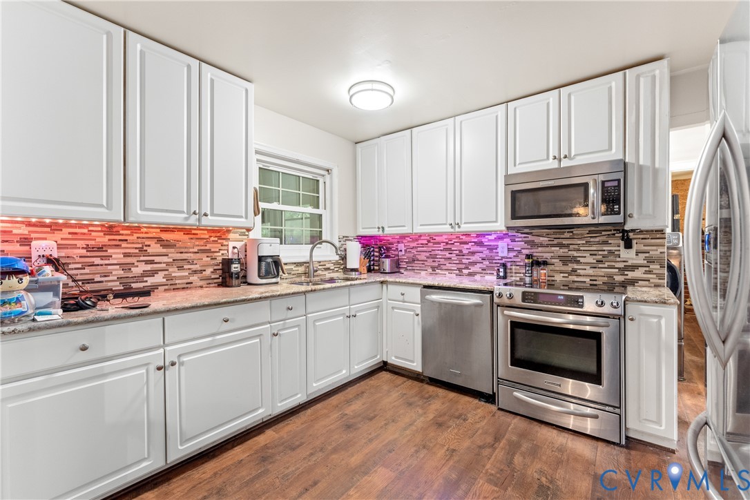 10709 Solaris Court Chesterfield, VA 23832 - Photo 9 of 34 a kitchen with granite countertop a sink stainless steel appliances and cabinets