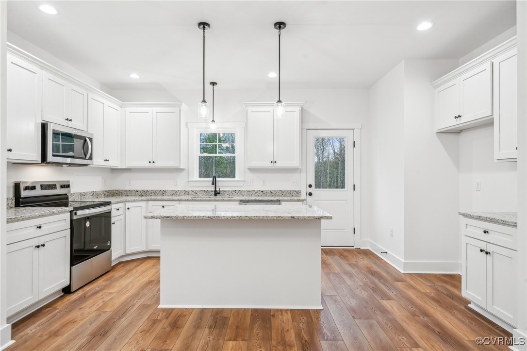 2467 Judes Ferry Road Powhatan, VA 23139 - Photo 12 of 36 a kitchen with stainless steel appliances granite countertop a sink a stove and a wooden floors