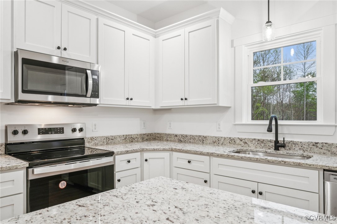 2467 Judes Ferry Road Powhatan, VA 23139 - Photo 17 of 36 a kitchen with granite countertop white cabinets and stainless steel appliances