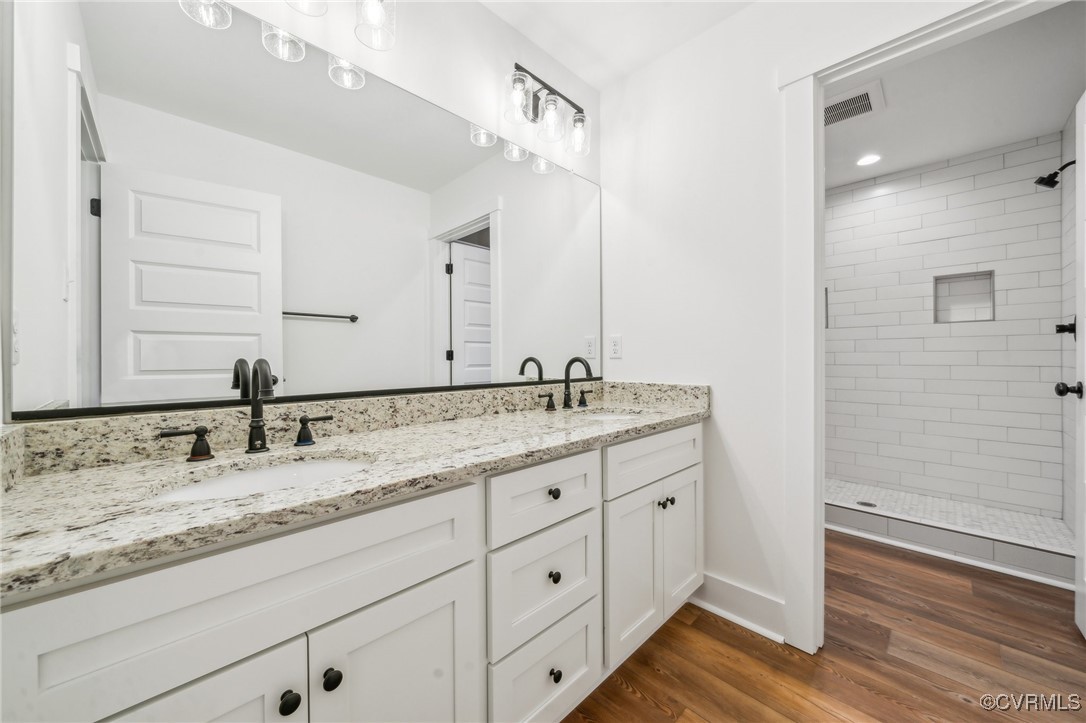 2467 Judes Ferry Road Powhatan, VA 23139 - Photo 22 of 36 a bathroom with a granite countertop sink and a mirror