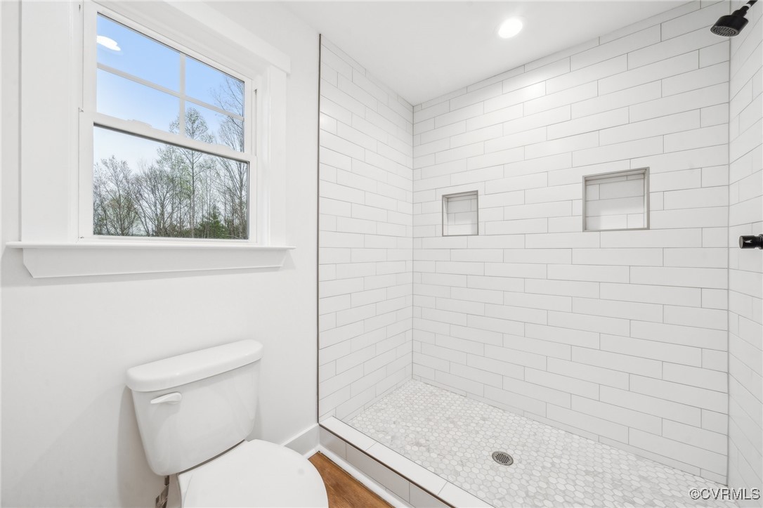 2467 Judes Ferry Road Powhatan, VA 23139 - Photo 23 of 36 a bathroom with a toilet and shower