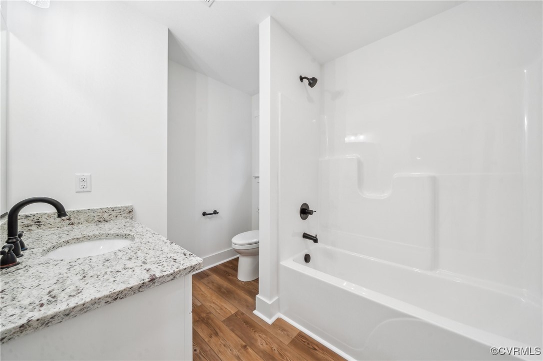 2467 Judes Ferry Road Powhatan, VA 23139 - Photo 27 of 36 a bathroom with a granite countertop sink a toilet and bathtub