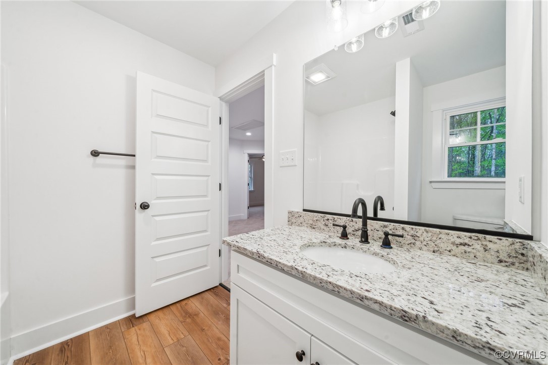 2467 Judes Ferry Road Powhatan, VA 23139 - Photo 28 of 36 a bathroom with a granite countertop sink and a mirror