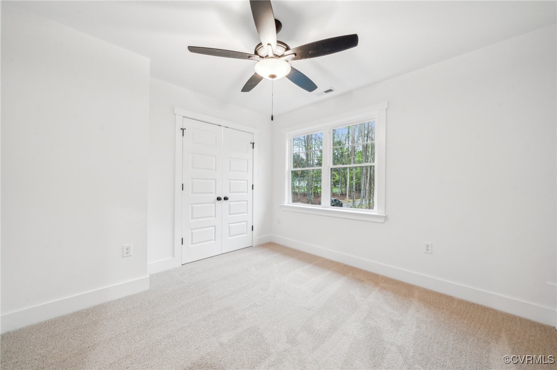 2467 Judes Ferry Road Powhatan, VA 23139 - Photo 29 of 36 an empty room with windows and fan