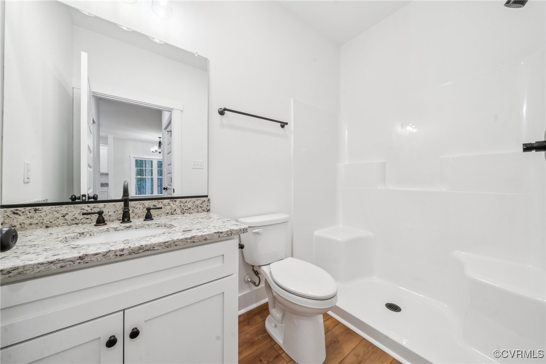 2467 Judes Ferry Road Powhatan, VA 23139 - Photo 33 of 36 a bathroom with a granite countertop sink a toilet and shower