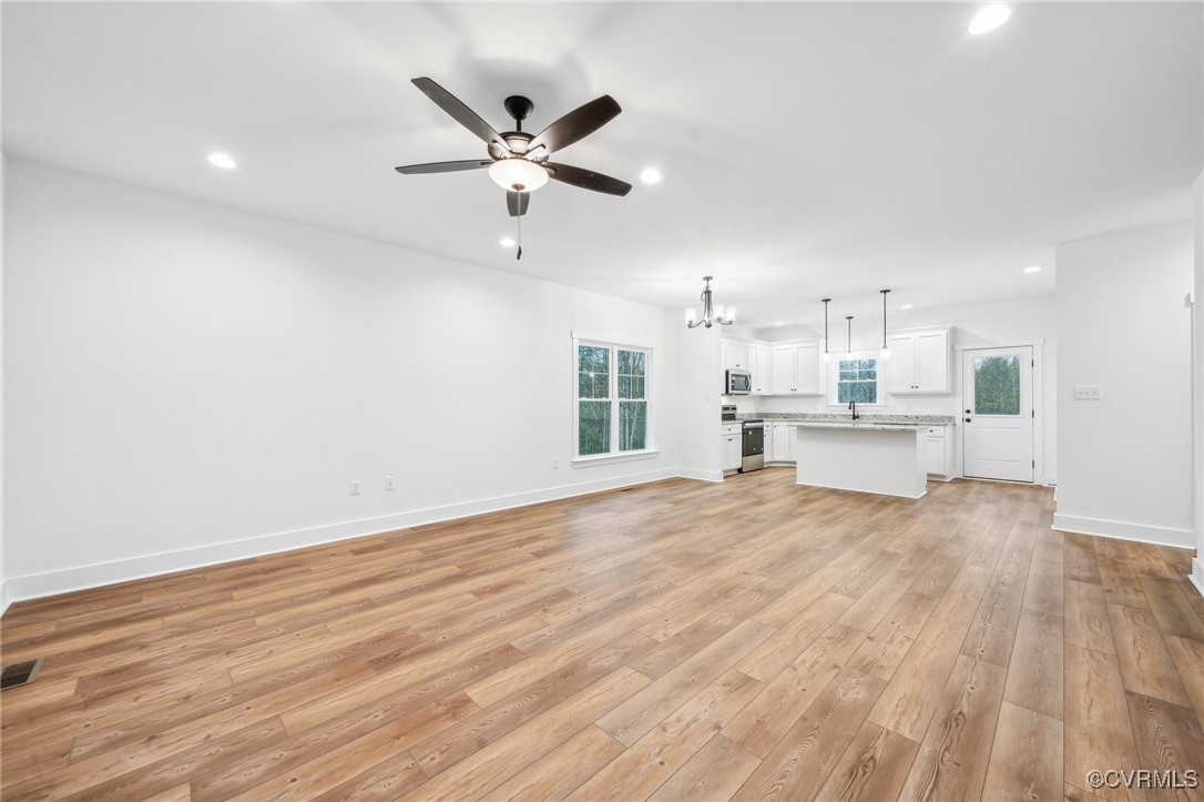 2467 Judes Ferry Road Powhatan, VA 23139 - Photo 5 of 36 a view of a kitchen with a sink and a wooden floor