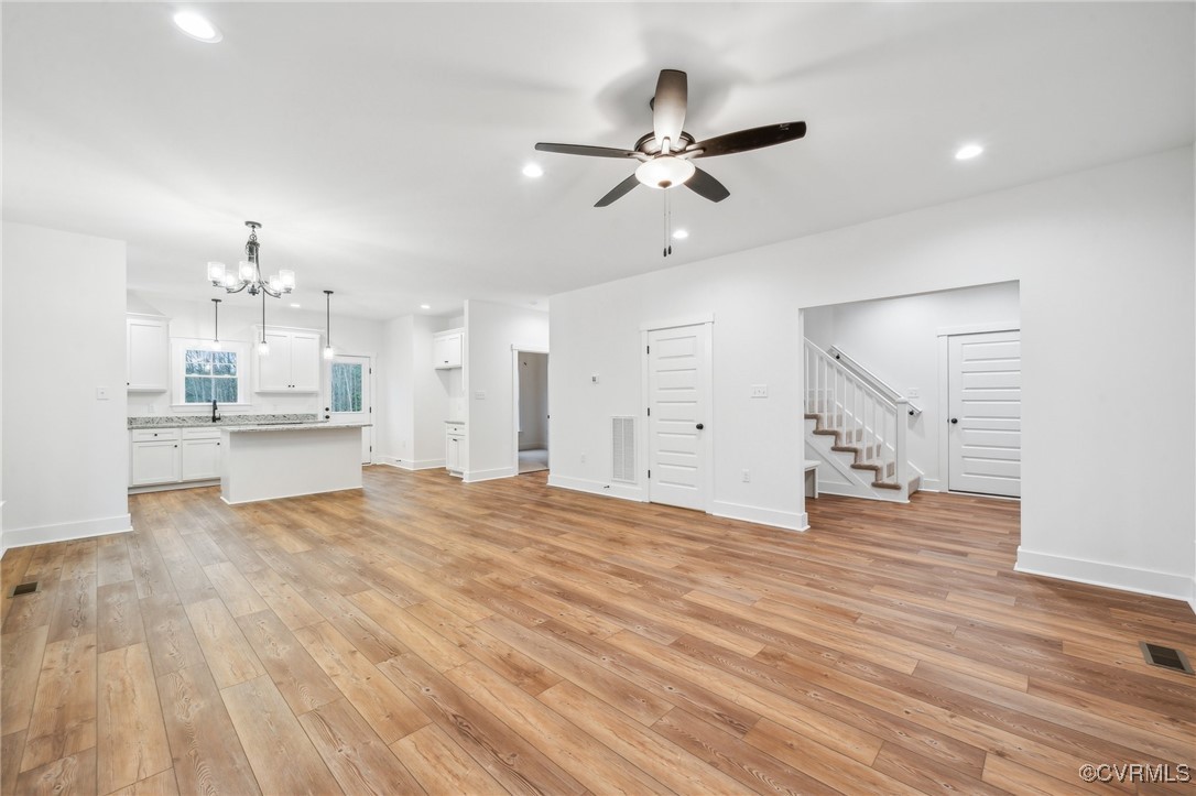 2467 Judes Ferry Road Powhatan, VA 23139 - Photo 6 of 36 a view of an empty room with wooden floor and a kitchen