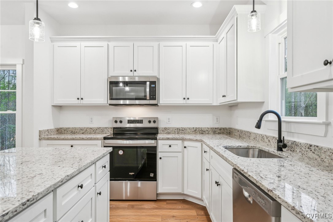 2467 Judes Ferry Road Powhatan, VA 23139 - Photo 9 of 36 a kitchen with granite countertop a sink a stove and cabinets
