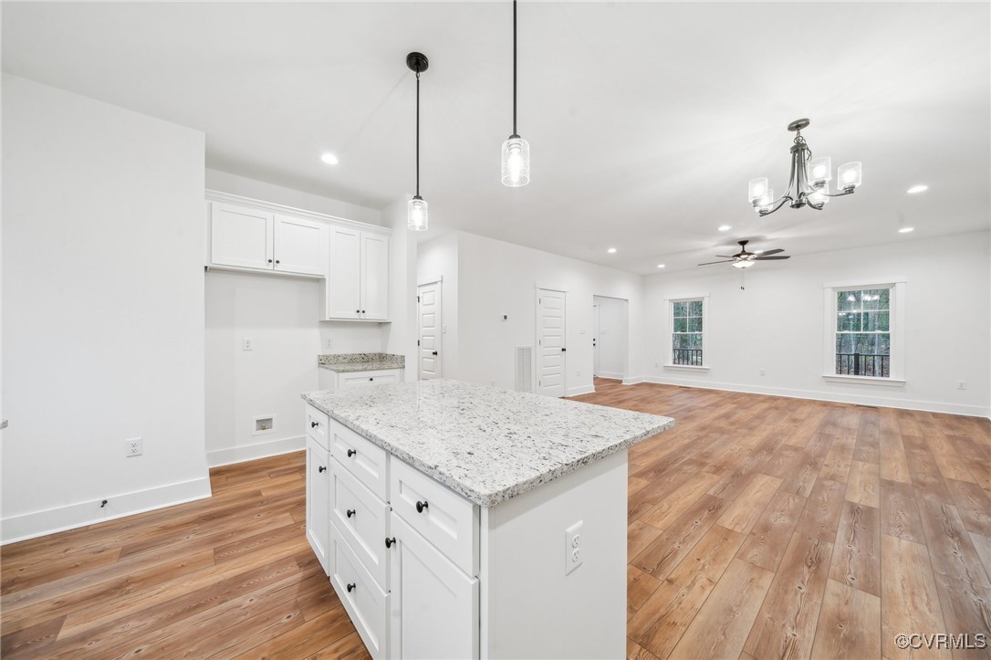 2467 Judes Ferry Road Powhatan, VA 23139 - Photo 10 of 36 a kitchen with a sink chandelier and wooden floor