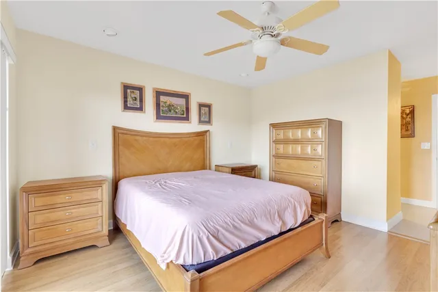 a view of a hallway with wooden floor and a kitchen