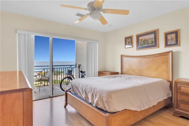 a bedroom with a bed and a mirror on dresser