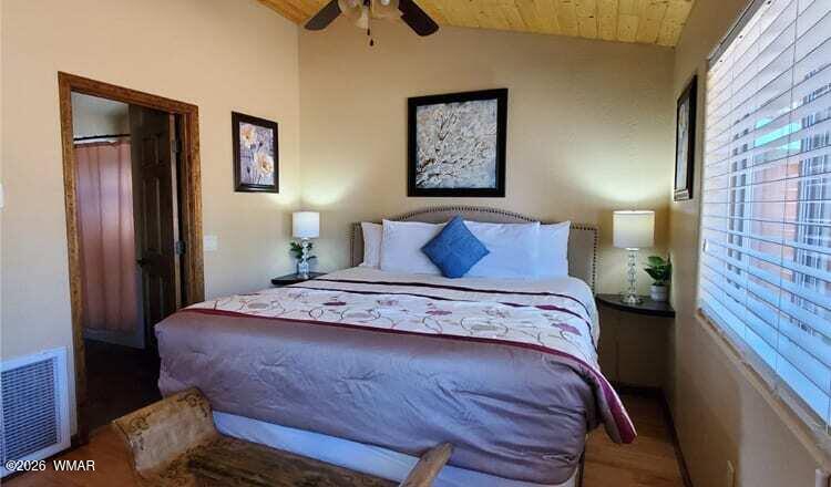 97 Rohrer Road Greer, AZ 85927 - Photo 10 of 14 a bedroom with a bed and a painting on the wall