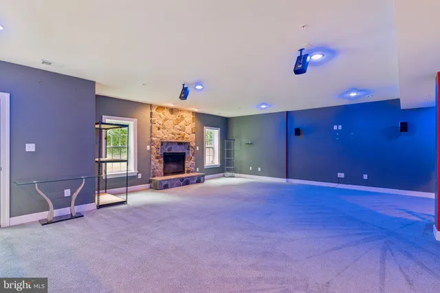 a view of an empty room with a fireplace and a window