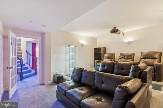 a living room with furniture and a ceiling fan