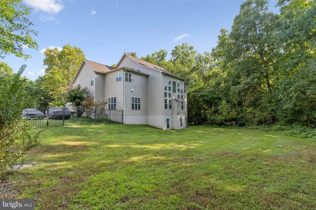 a view of a backyard with a garden and entertaining space