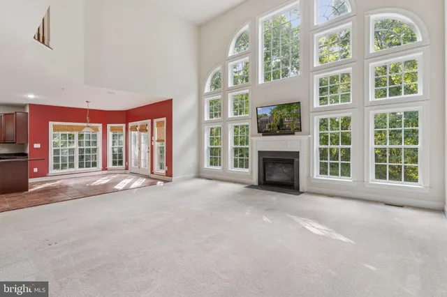 a view of an empty room with a fireplace and a window