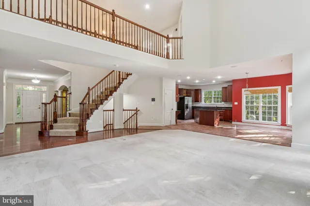 a view of an empty room with stairs and furniture