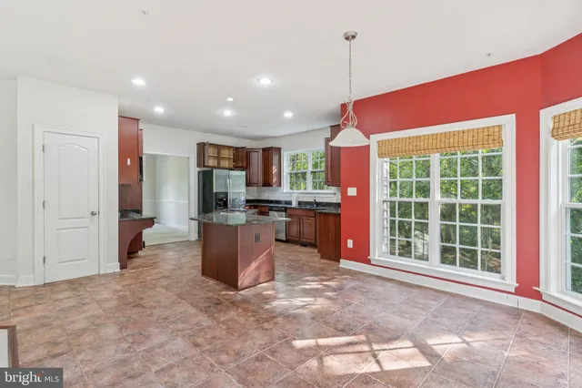 a kitchen with a refrigerator and a sink