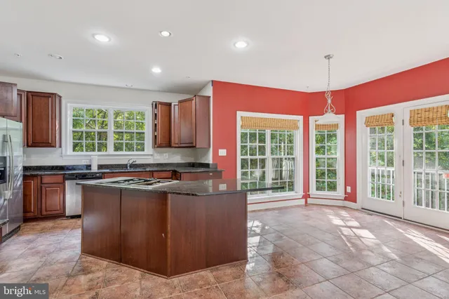 a kitchen with stainless steel appliances granite countertop a stove and a sink