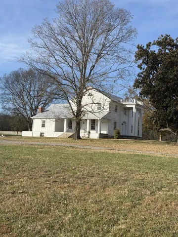 a front view of house with yard and trees