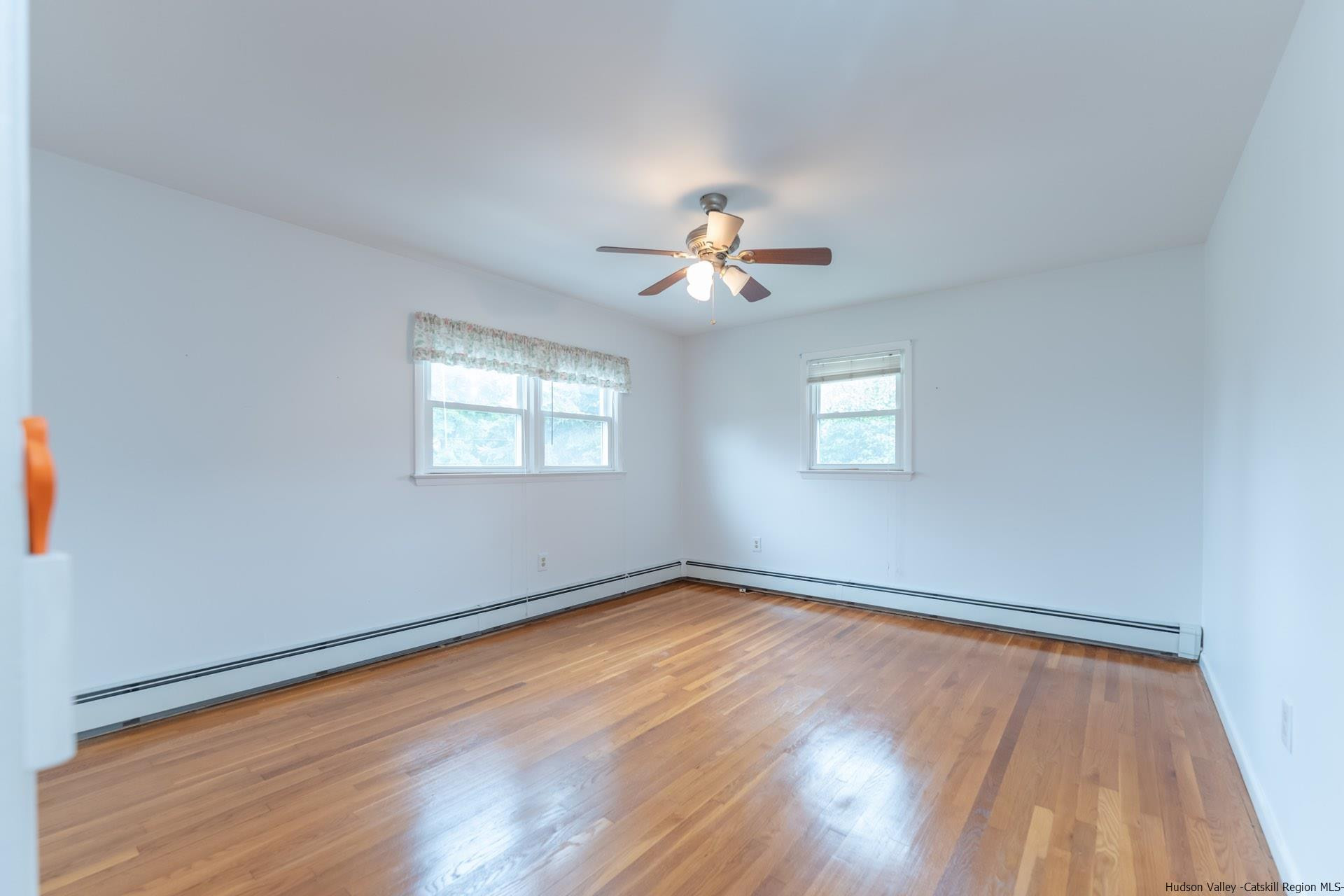 2 Magic Drive Kingston, NY 12401 - Photo 18 of 27 an empty room with wooden floor chandelier fan and windows
