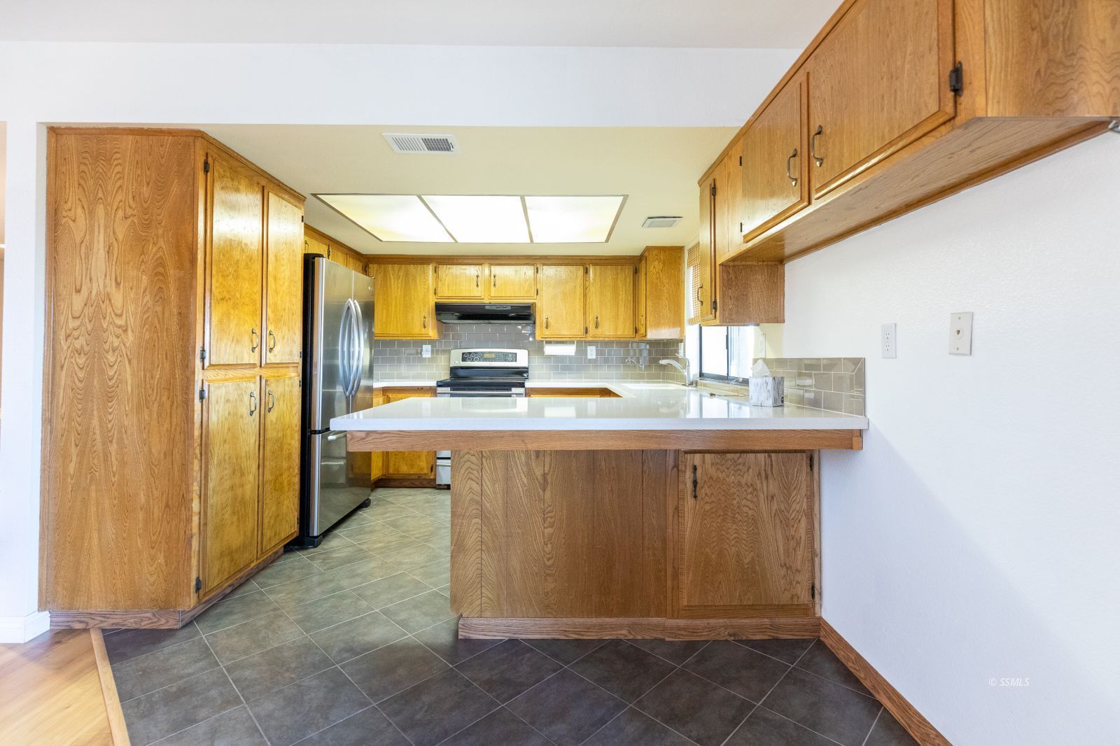 361 North Wildflower Street Ridgecrest, CA 93555 - Photo 14 of 39 a kitchen with stainless steel appliances granite countertop a refrigerator a sink and a cabinets