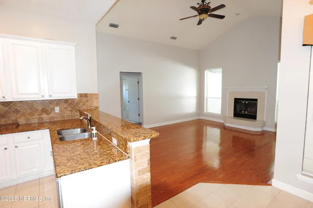 a living room with hard wood floors and a fireplace