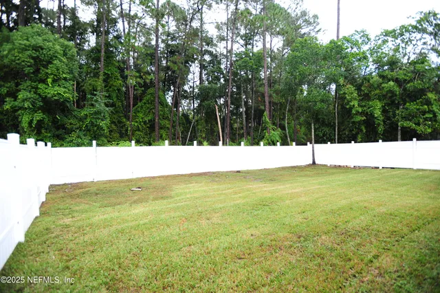 a backyard of a house with lots of green space