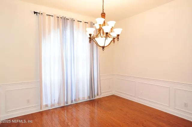 a view of a hallway with a chandelier