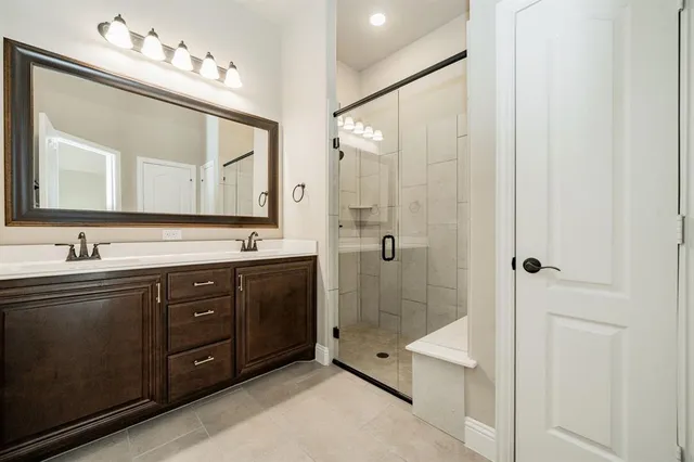 a spacious bathroom with a double vanity sink mirror double and shower