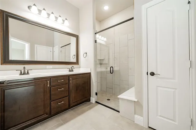 a spacious bathroom with a double vanity sink mirror double and shower