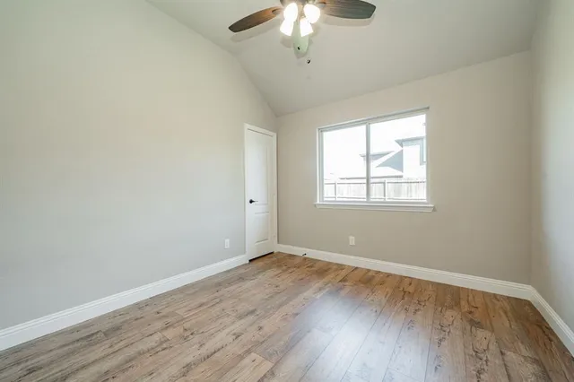 a view of a room with wooden floor and windows