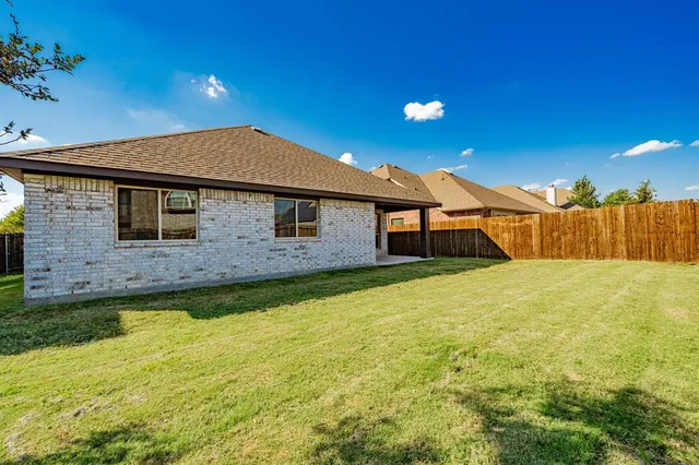 a backyard of a house with lots of green space