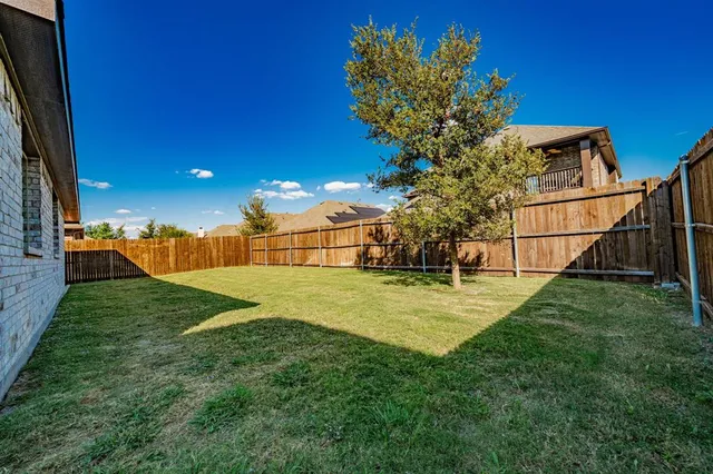 a view of a garden with a house
