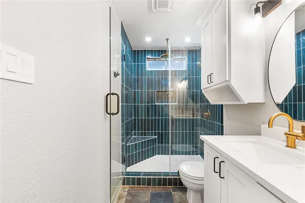 a bathroom with a sink toilet and shower