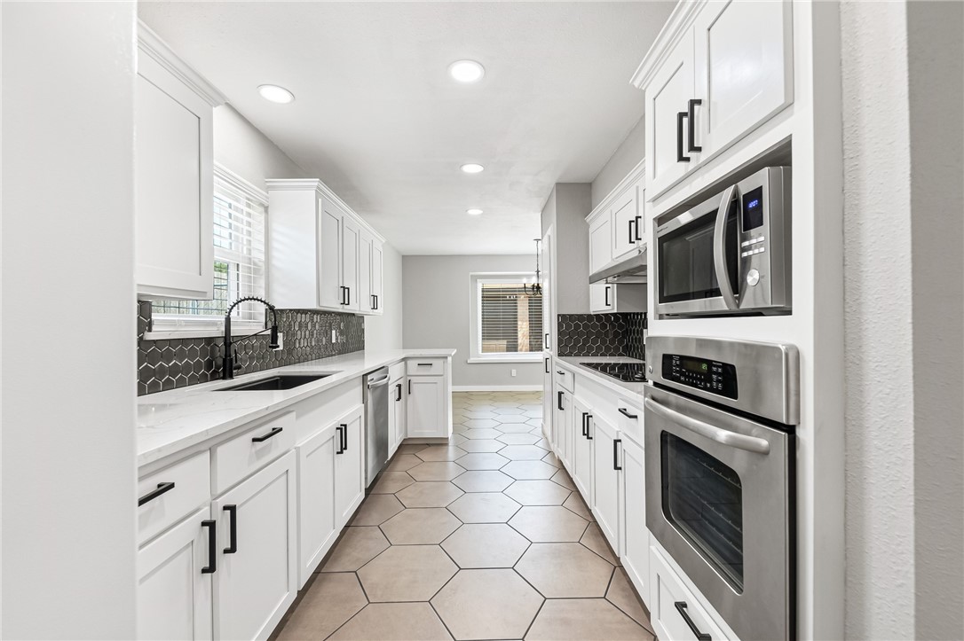 5038 Crestwick Drive Corpus Christi, TX 78413 - Photo 17 of 28 a large kitchen with stainless steel appliances granite countertop a lot of counter space and a sink