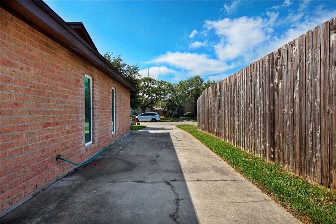 5038 Crestwick Drive Corpus Christi, TX 78413 - Photo 24 of 28 a view of a pathway with a wooden fence