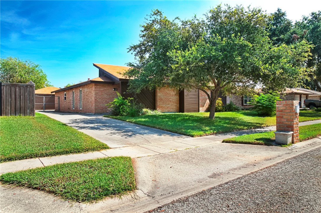 5038 Crestwick Drive Corpus Christi, TX 78413 - Photo 25 of 28 a view of a back yard with flower plants and wooden fence