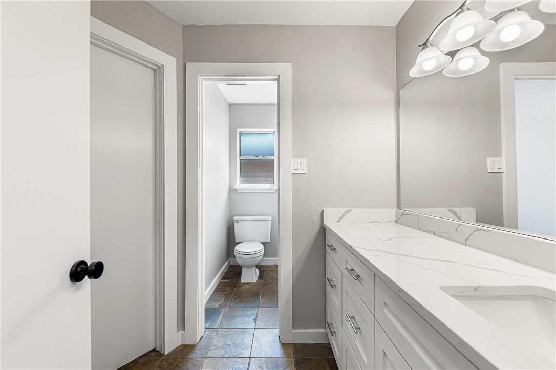 5038 Crestwick Drive Corpus Christi, TX 78413 - Photo 9 of 28 a spacious bathroom with a sink a toilet and a mirror