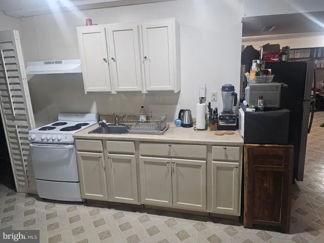 a kitchen with cabinets appliances and a sink