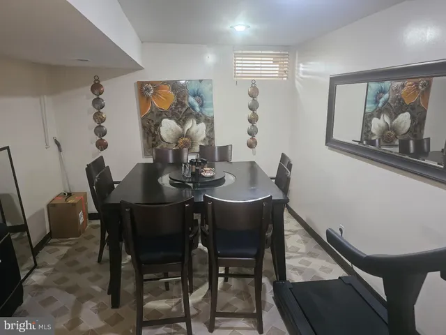 a view of a dining room with furniture a rug and wooden floor