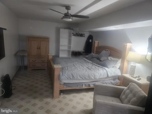 a bedroom with a bed and a couch