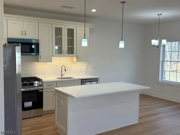 a kitchen with a sink a stove and cabinets