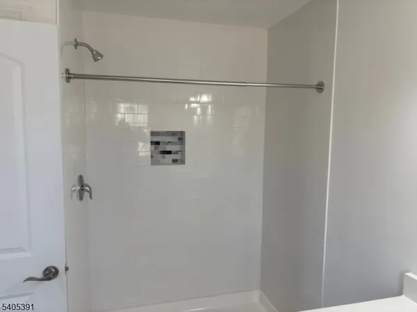 a bathroom with a glass shower door