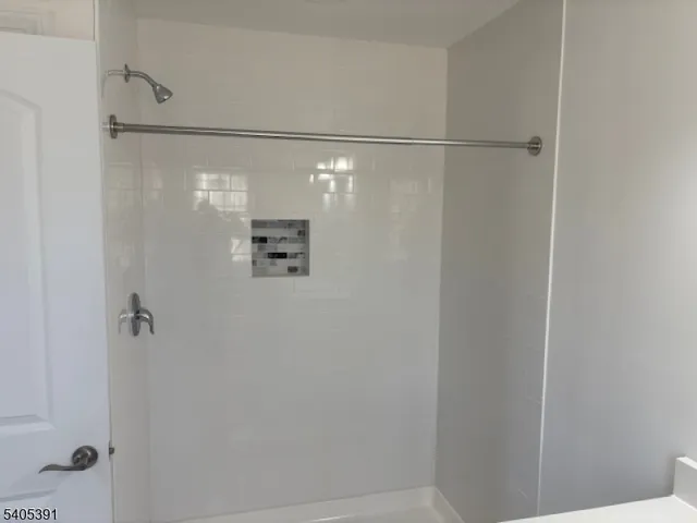 a bathroom with a glass shower door