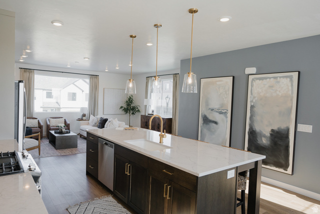 2012 West 1150 South, Unit 1018 Payson, UT 84651 - Photo 4 of 25 Kitchen featuring light stone counters, dark wood-style floors, a kitchen island with sink, and pendant lighting