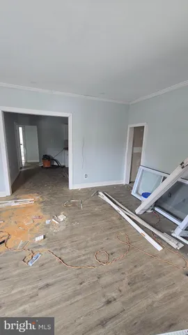 a view of a room with wooden floor