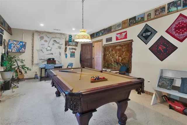 a kitchen with stainless steel appliances granite countertop a refrigerator a sink dishwasher and wooden cabinets with wooden floor