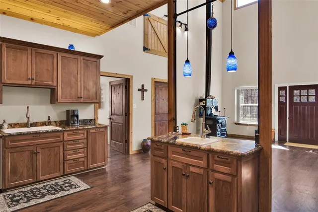 a view of a kitchen with stainless steel appliances granite countertop a stove and a refrigerator